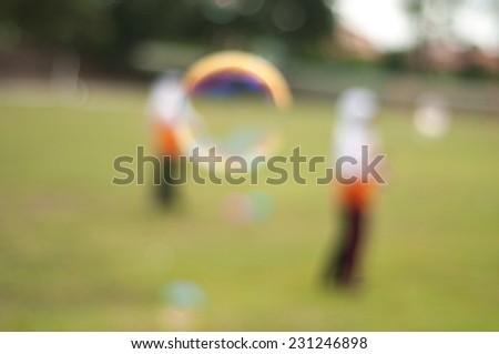Blur image of children playing giant bubble