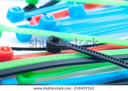 self-locked plastic zip cable ties in different colors over white background