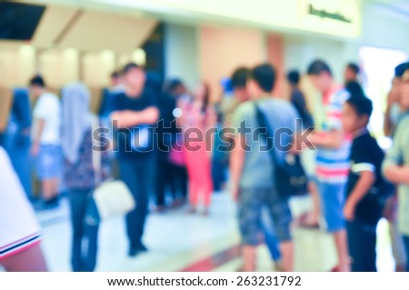 Blur image of people queue at automatic teller machine (ATM)