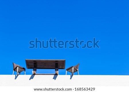 Business Meeting Fallout Edge Desk Chairs Table desk and chairs on edge of building in the blue sky