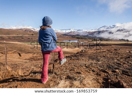 Girl Mountains Exploring Young girl dressed warm overlooking exploring adventure in the winter snow mountain valley terrain landscape