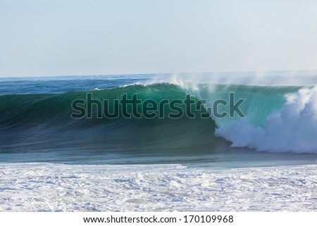 Ocean Wave Size Good size ocean wave swell crashing breaking on beach shallow sandbars