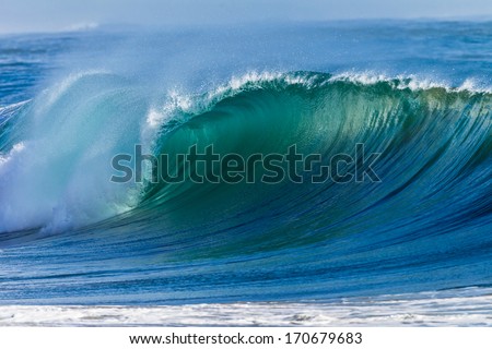 Ocean Wave Curl  Clean ocean wave rolling curling lip crashing on shallow sandbars.