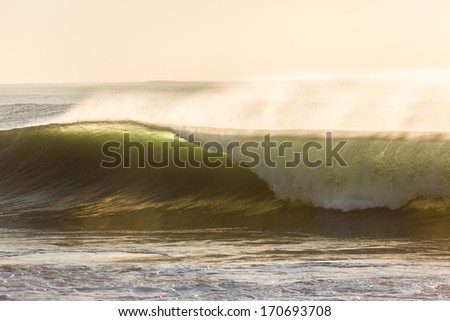 Wave Crashing Water Ocean waves with shape power and crashing onto shallows in morning light