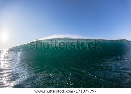 Ocean Wave Swimming Ocean wave wall of sea water upright cresting crashing towards swimmers position.