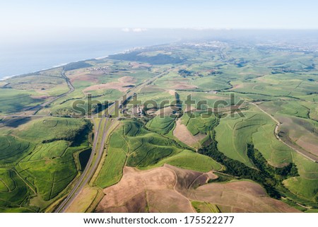 Air Flying Landscape Sugarcane Highway Ocean Air flying birds eye view of sugarcane farming fields highways twisting over the colorful landscape to the ocean