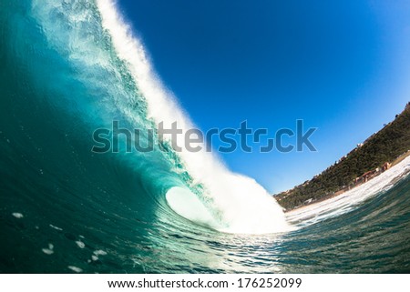 Big Wave Hollow Crashing Water Big ocean blue wave crashing onto shallow reefs, a swimming surfers view of water power and energy