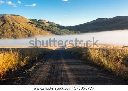 Dirt Road Mist Mountains Mountain wilderness Dirt Road with mist rising from rivers nearby