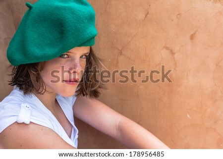Teen Girl Mood Beret Teen girl close portrait healthy,fit, moods, serious wearing green beret hat white top.