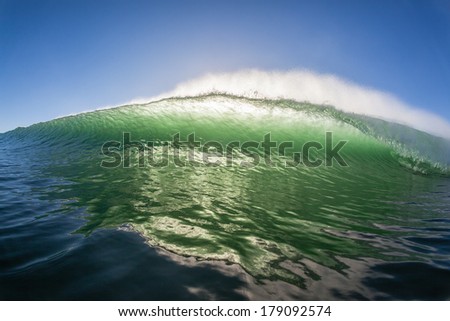 Ocean Wave Colors Water  Ocean wave back-light in color contrasts crashing towards swimmer surfer position in water