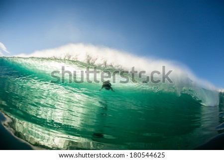 Wave Crashing Surfer Shadow Hollow wave crashing with surfer shadow in wall of water