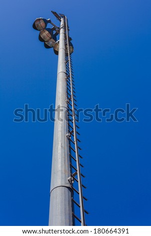 Electrical Flood Lights Blue Sky Tall electrical steel tower floodlights with high powered lights for nighttime events in blue sky