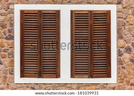 Window Wood Shutters Home Two windows wood shutters closed side by side for privacy and security of house room
