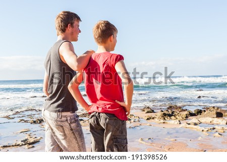 Teen Boys Beach Family Holiday Teen boys family together overlooking beach ocean water landscape