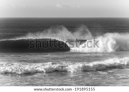 Ocean Wave Crashing Sepia Tone Ocean wave crashing along shallow reefs with natures power and energy in black and white tone for mood contrast.