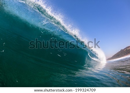 Blue Wave Swimming Inside Crashing Water Ocean sea swimming closeup to glass smooth blue water wave wall vertical pitching crashing power beauty of nature.