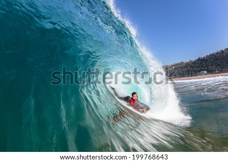 Surfing Body-Boarder Rides Wave Water Action Surfing  body-boarder tube rides hollow crashing blue ocean wave, closeup action water photo