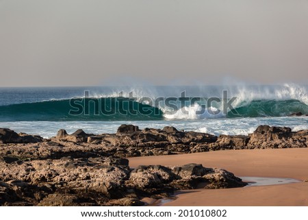 Wave Crashing Blue Rocks Blue Blue ocean wave crashing breaking water onto beach rocks shallow reefs sandbars