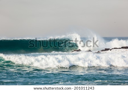 Ocean Wave Upright Crashing Rocks Blue ocean wave upright crashing breaking onto beach shallow reefs sandbars