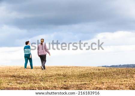 Women Walking Outdoors Countryside Women mother daughter walking away talking outdoors countryside nature reserve