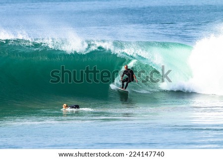 Surfing Surfer Excitement  Surfing surfer exits ocean wave  hollow tube ride