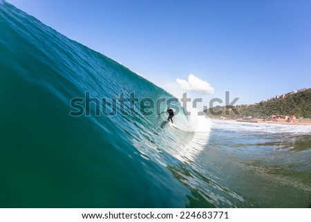 Surfing Inside Hollow Wave Surfing surfer tube rides inside hollow crashing blue water ocean wave