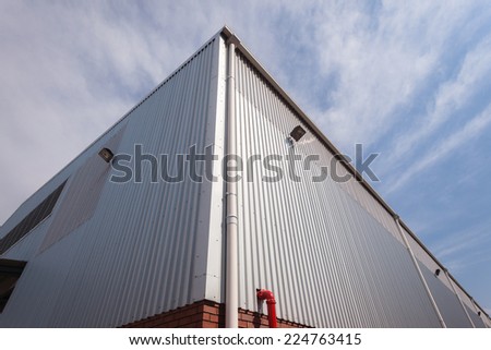 Building Corner Meat Sheeting Corner section of factory warehouse building built with metal  structure with  roofing cover sheeting and brick block walls