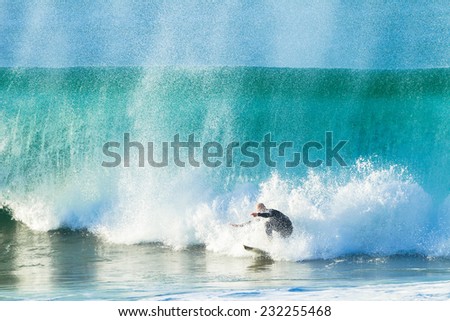 Surfer Escape Crashing Wave Surfing surfer rides straight to ecape crashing hollow wave from a beating wipe-out.