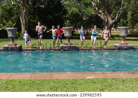 Boys Girls Jumping Swim Pool Teenagers boys girls running jumping into swimming home summer playtime
