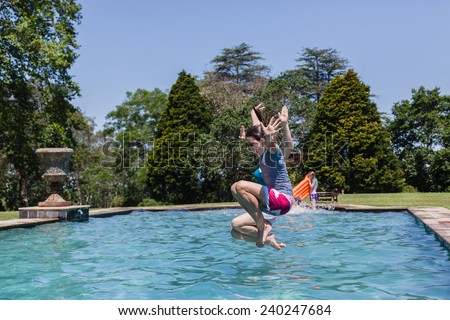 Girls Jumping Pool Girls teenagers jumping into swimming pool home summer