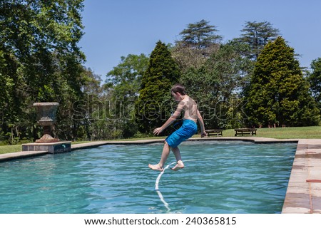 Boy Jumping Pool Boy jumping into swimming pool  home summer.