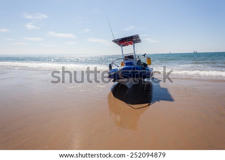 Fishing Boat Beach Fishing rubber inflatable boat resting on beach sand ocean sea waters