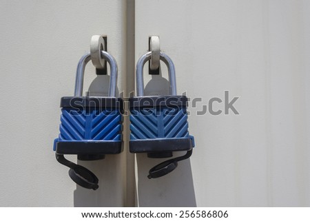 Locks Security\
Two locks on panel doors for security of unit in black white vintage