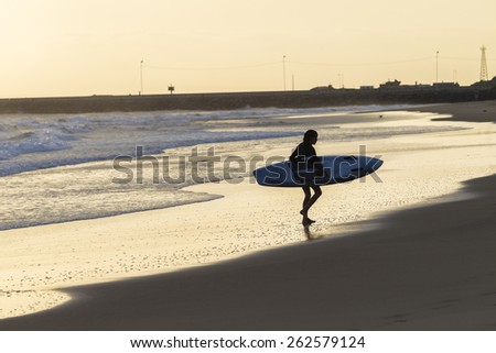 Girl Rescue Craft Beach Waves
Teen girl athlete trains dawn sunrise on rescue craft paddling out through ocean wave swells.