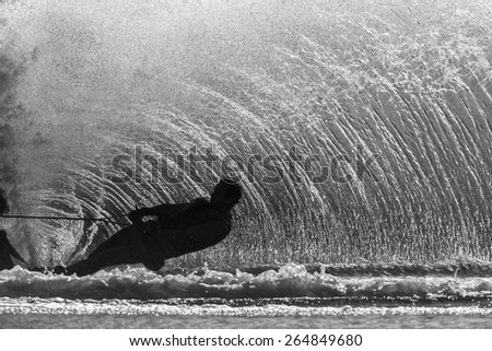 Water Skier Action Black White\
Water skier hard turn wake of upright water wall spray off ski in black and white vintage.