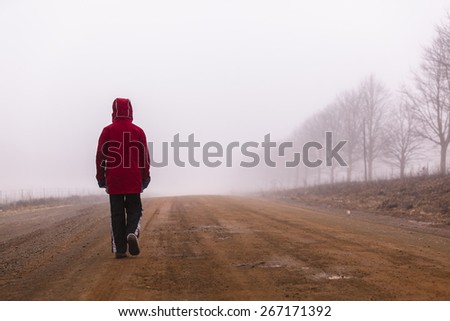 Teen Walking Dirt Road Mist\
Teenager boy walking rural mountain farm dirt road in morning cloud mist