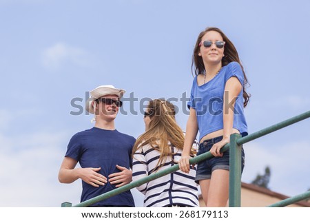 Boy Girls Beach Socializing\
Boy girl teenagers at beach holidays talk laughter socializing hangout.
