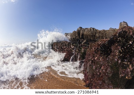 Wave Beach Water Rocks Ocean wave white water shore break crashing into rocks along beach
