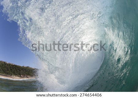 Wave Blue Ocean wave hollow crashing blue water tube swimming closeup.