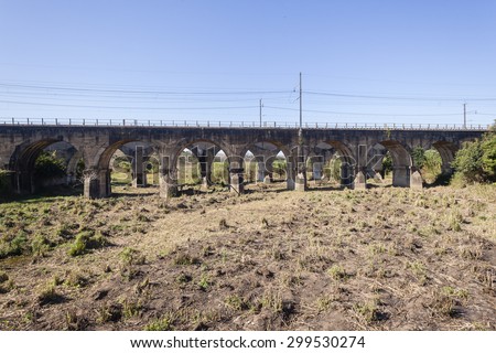 Train Railway Bridge Arches\
Train railway bridge concrete arches two bridges over dry river bed landscape