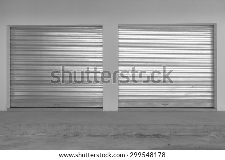 New Double Garage Doors Vintage\
New double sheet metal garage doors installed into  building in black white vintage.