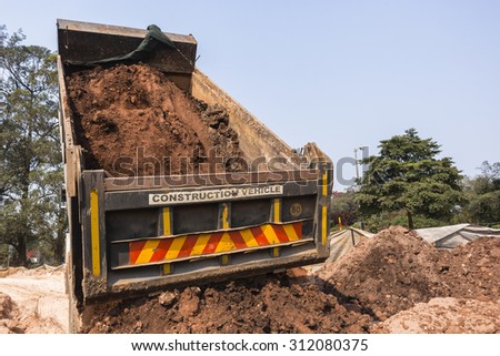 Truck Earthworks Dumping\
Construction truck vehicle tipping dumping raw earth soil on site