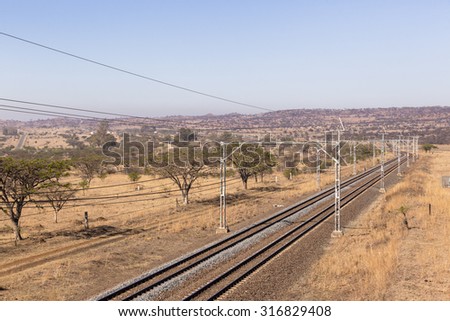 Railway Tracks Dry Landscape\
Railway train tracks line travel through dry season rural landscape
