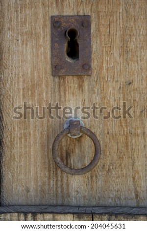 old lock in a wooden door and knob