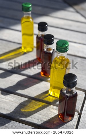 bottles of oil and vinegar on top of a wooden table