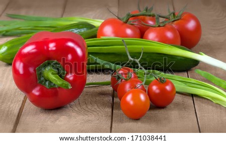 collection of fresh raw vegetables isolated on white background on kitchen wooden board