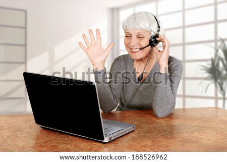 elderly woman senior at the computer communicates laptop, grandmother