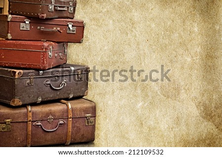 retro bags suitcases valise on the old vintage textured paper background collection