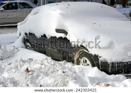 Odessa, Ukraine - 30 December, 2014: car under snow,  Natural disasters, blizzard, heavy snow paralyzed the city, collapse. Snow covered cars cyclone Europe