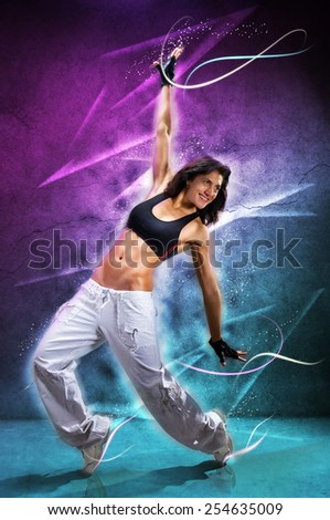 Young beautiful  woman dancing modern dance hip-hop on colorful  background. With lights effect.